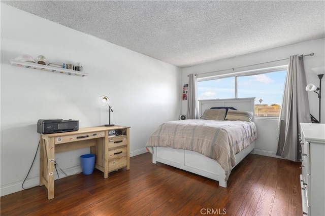 bedroom featuring dark wood-type flooring and a textured ceiling