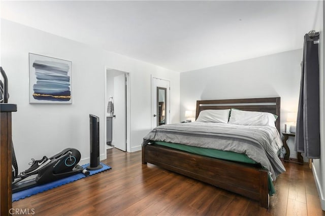 bedroom with dark hardwood / wood-style floors