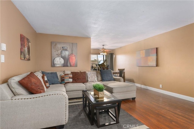 living room featuring ceiling fan and wood-type flooring