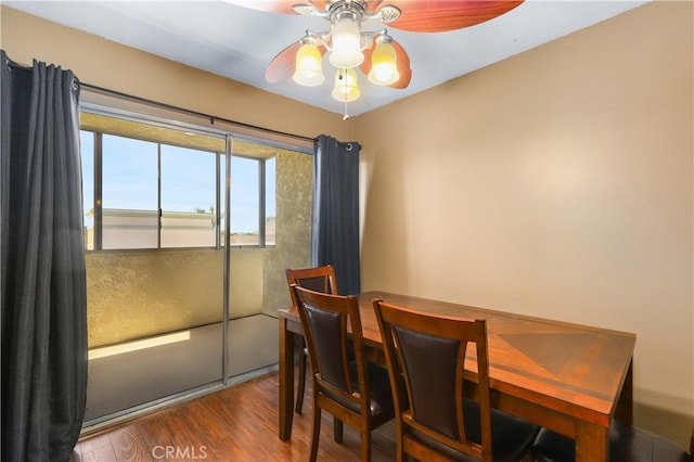 dining space featuring ceiling fan and wood-type flooring