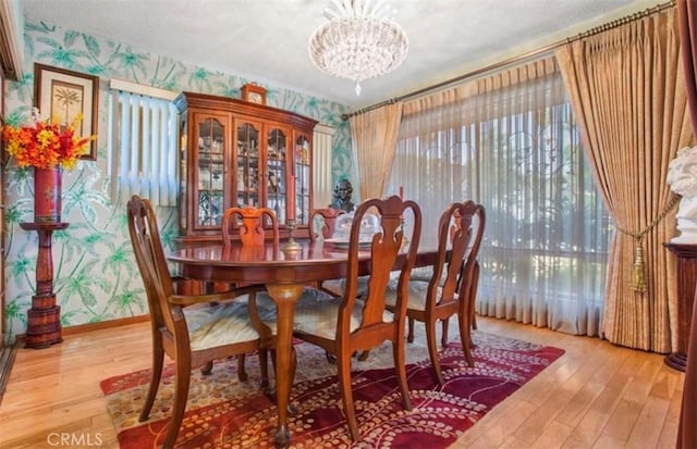 dining room with wood-type flooring and a notable chandelier