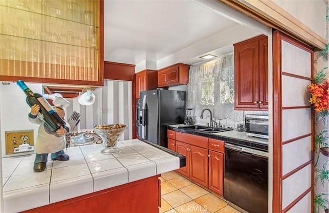 kitchen with dishwasher, sink, stainless steel fridge, tile countertops, and light tile patterned floors