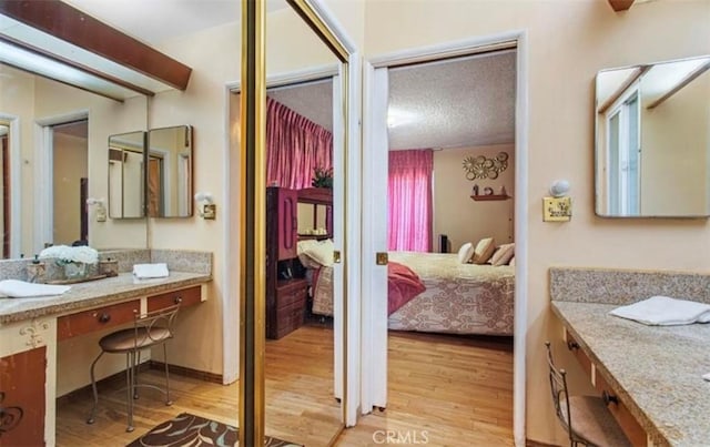 bathroom with hardwood / wood-style floors and vanity