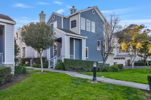 view of property with a garage and a front yard