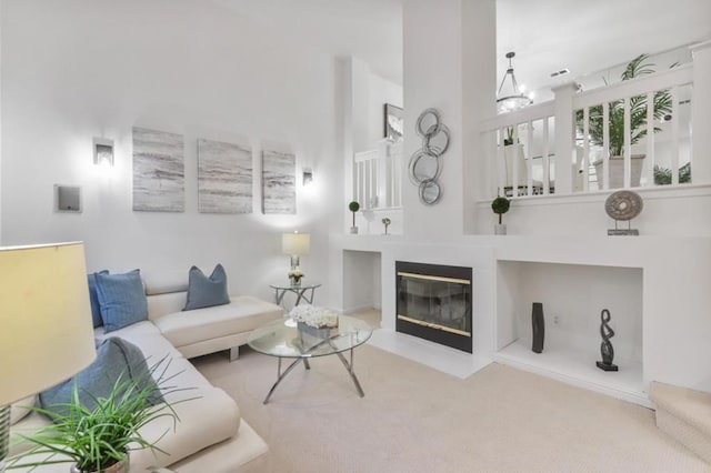 living room with light colored carpet and a chandelier