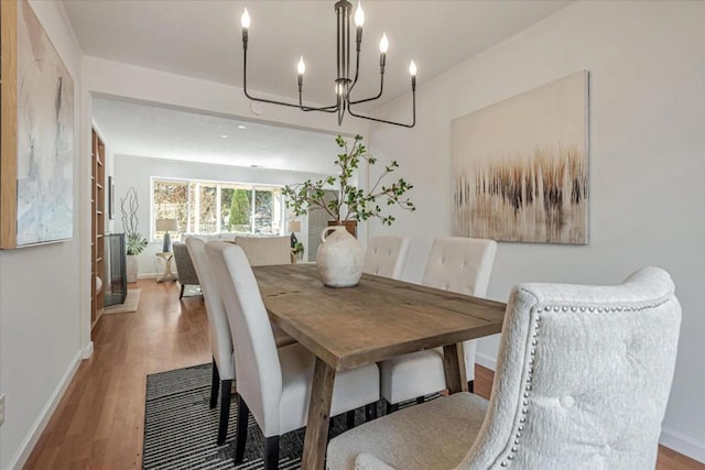 dining area featuring a notable chandelier and hardwood / wood-style floors