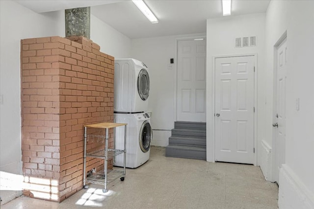 laundry room featuring stacked washer and dryer