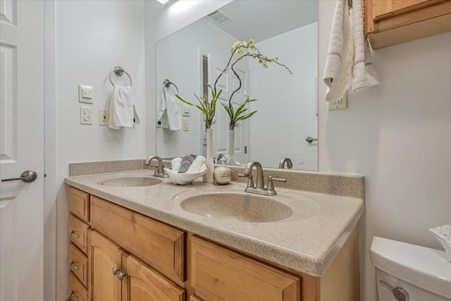 bathroom with toilet and vanity