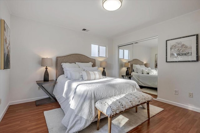 bedroom featuring hardwood / wood-style flooring and a closet