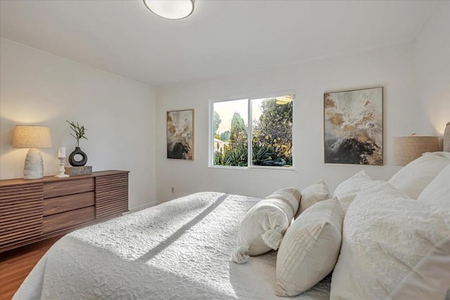 bedroom with hardwood / wood-style floors