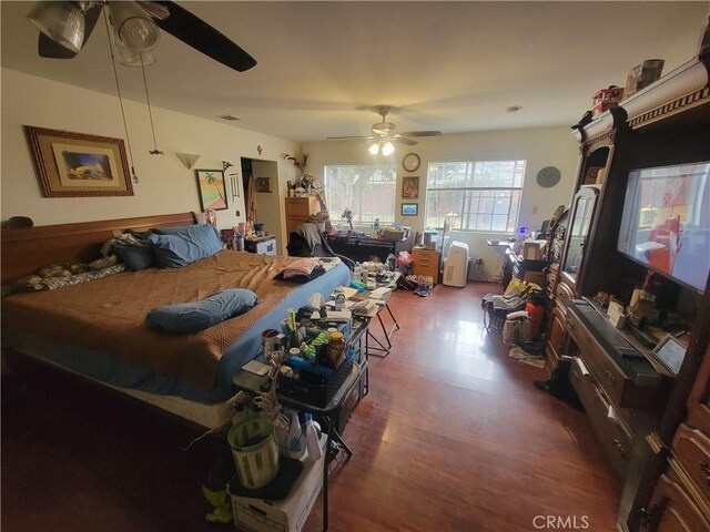 living room with ceiling fan and hardwood / wood-style floors