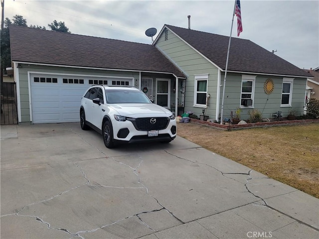 view of front of property featuring a front yard and a garage