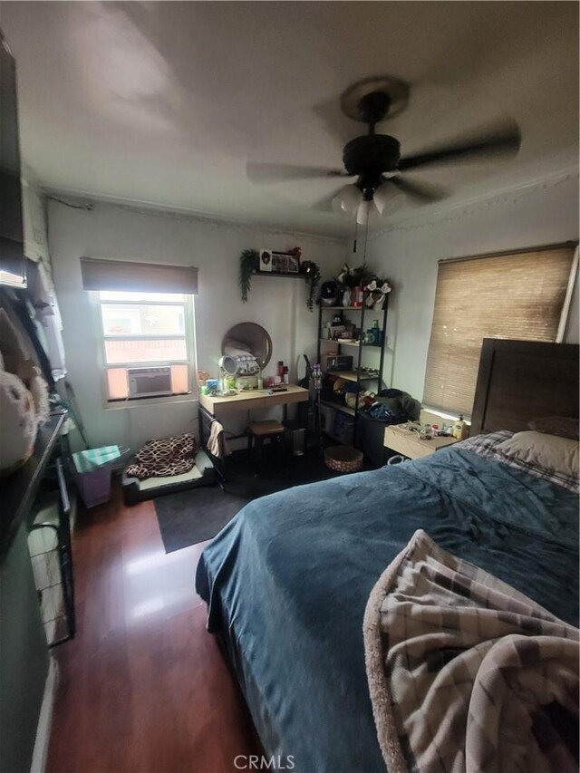 bedroom with ceiling fan and cooling unit