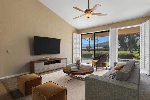 carpeted living room featuring ceiling fan and lofted ceiling