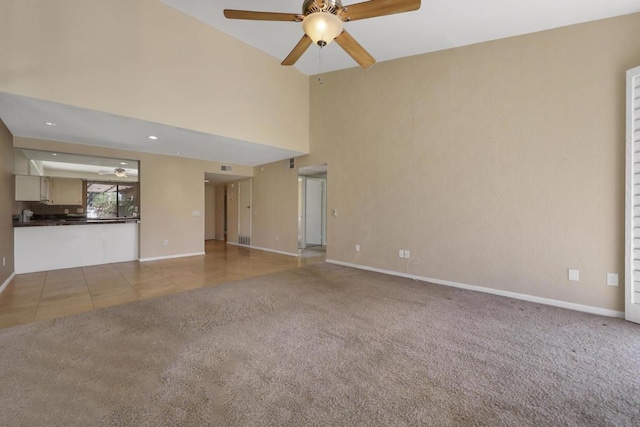 unfurnished living room featuring ceiling fan and light carpet