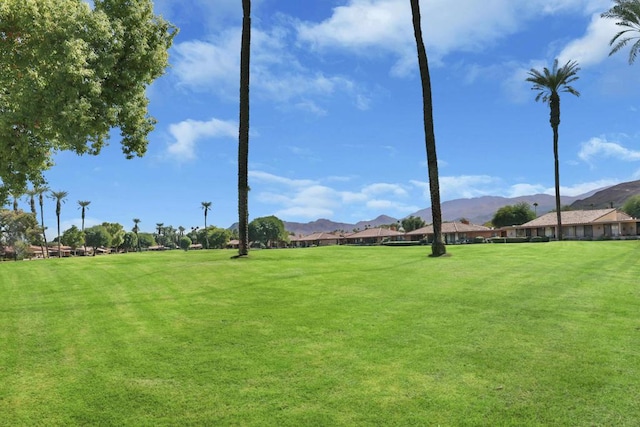 surrounding community featuring a mountain view and a yard