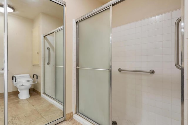 bathroom featuring toilet and walk in shower