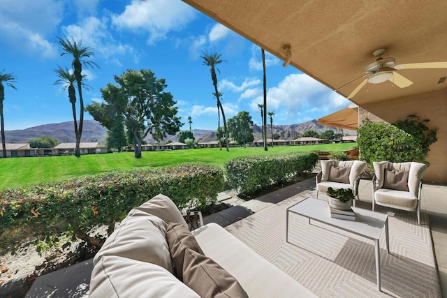 view of patio with a mountain view, ceiling fan, and an outdoor hangout area