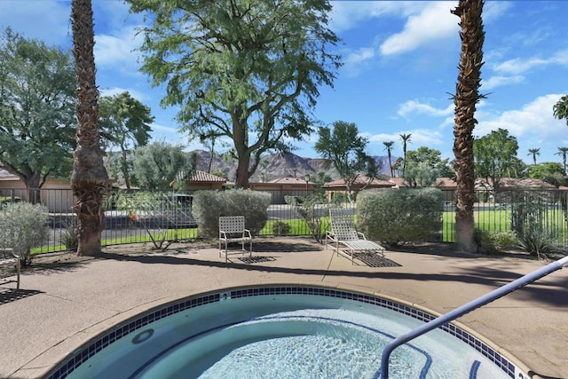 view of swimming pool with a patio area and a hot tub