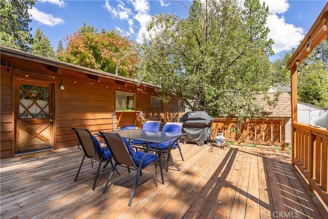 wooden terrace featuring grilling area