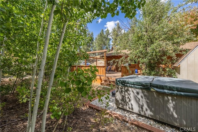 view of yard with a deck and a hot tub