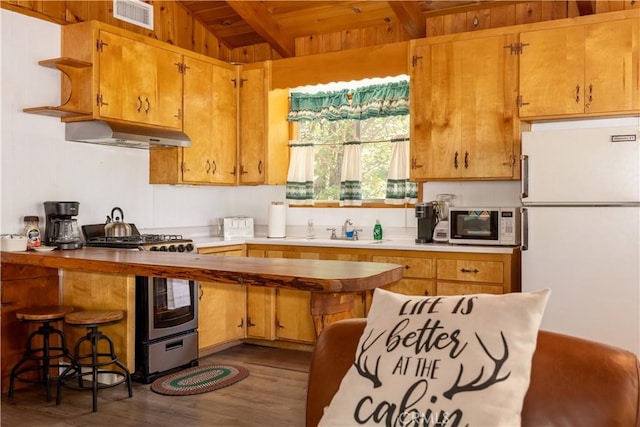 kitchen with white appliances, wood ceiling, vaulted ceiling with beams, sink, and dark hardwood / wood-style floors