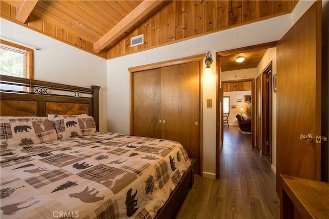 bedroom with a closet, dark hardwood / wood-style flooring, wood ceiling, and lofted ceiling with beams