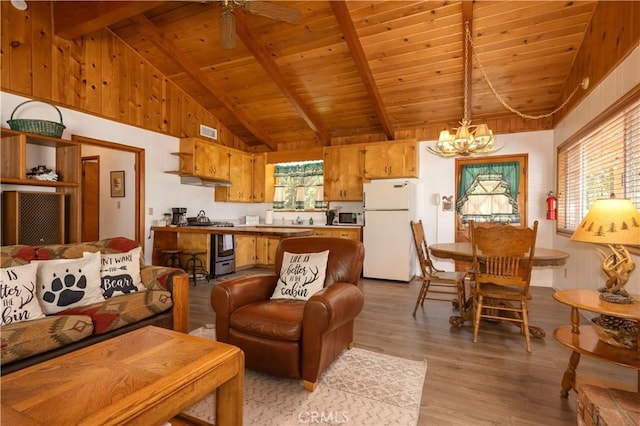 living room featuring ceiling fan with notable chandelier, wood ceiling, beamed ceiling, light wood-type flooring, and high vaulted ceiling