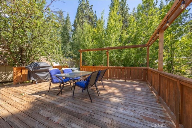 wooden deck featuring a grill