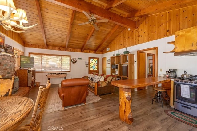 living room with beamed ceiling, hardwood / wood-style flooring, wood ceiling, high vaulted ceiling, and ceiling fan with notable chandelier