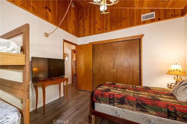 bedroom featuring dark hardwood / wood-style flooring, wood ceiling, and vaulted ceiling