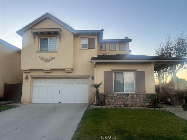 view of front of home featuring a garage and a lawn