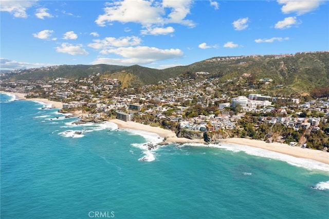 drone / aerial view with a view of the beach and a water and mountain view