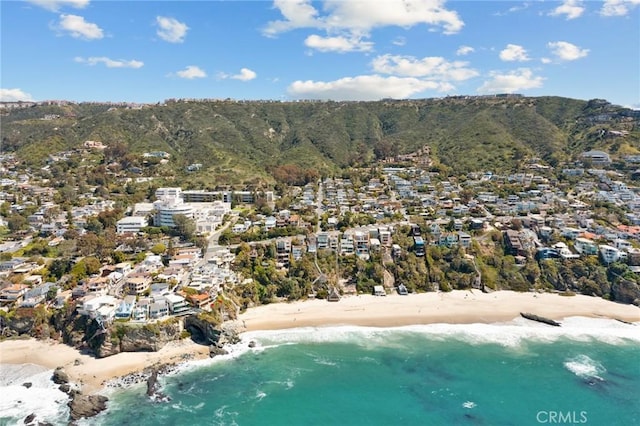 drone / aerial view featuring a water view and a beach view