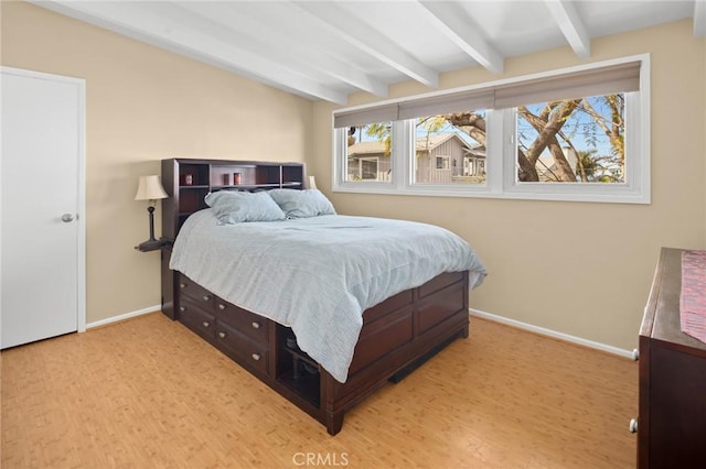 bedroom with beam ceiling and hardwood / wood-style flooring