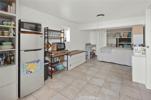 tiled bedroom with stainless steel fridge