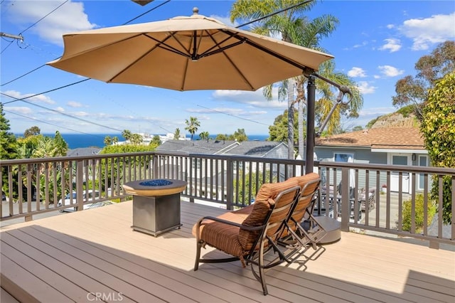 wooden deck with a fire pit