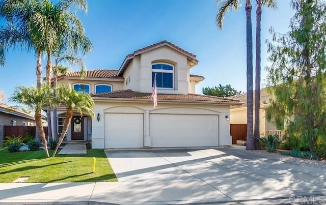 mediterranean / spanish-style house with a garage and a front yard