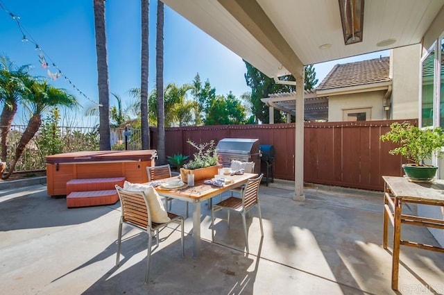 view of patio / terrace featuring a hot tub and a grill