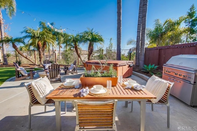 view of patio with a grill and a hot tub