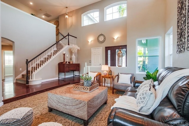 living room featuring hardwood / wood-style flooring and a high ceiling