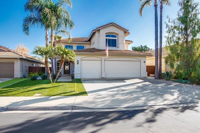 mediterranean / spanish house featuring a garage and a front lawn