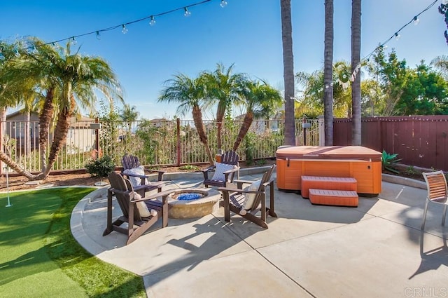 view of patio / terrace with an outdoor fire pit and a hot tub