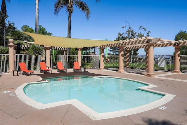 community pool featuring a patio area, fence, and a pergola