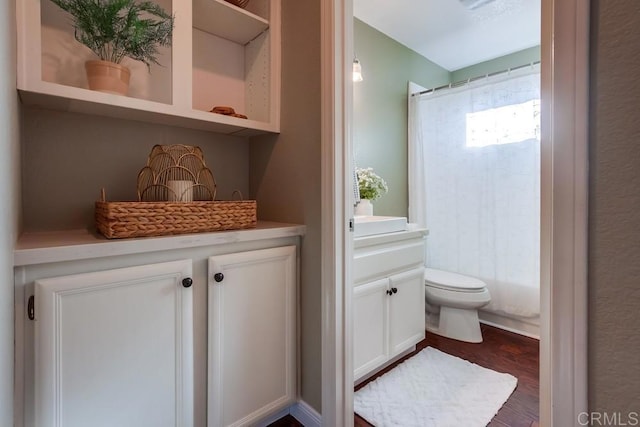 full bathroom featuring toilet, wood finished floors, and a shower with shower curtain