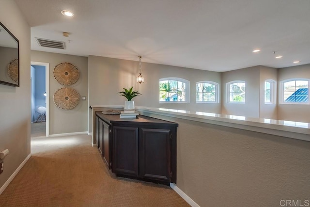 corridor featuring recessed lighting, light carpet, visible vents, and baseboards