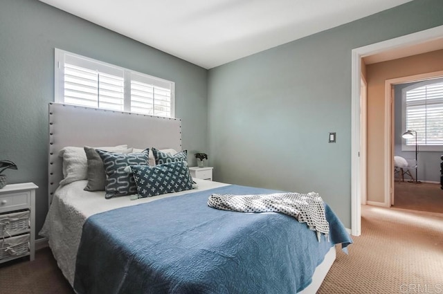 carpeted bedroom with baseboards