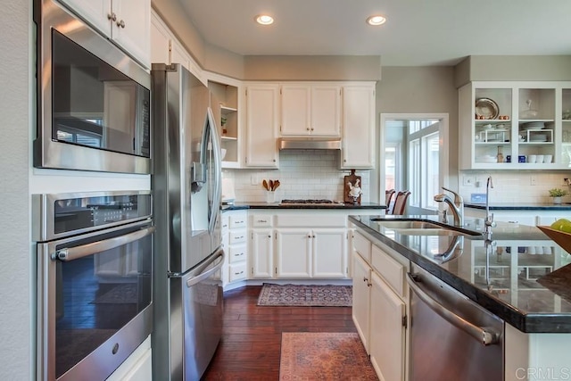 kitchen featuring stainless steel appliances, a sink, white cabinetry, and under cabinet range hood