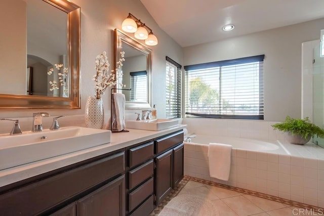 full bathroom with a wealth of natural light, tile patterned flooring, and a sink