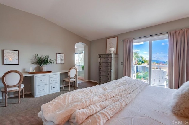 carpeted bedroom featuring baseboards, arched walkways, lofted ceiling, access to outside, and built in desk